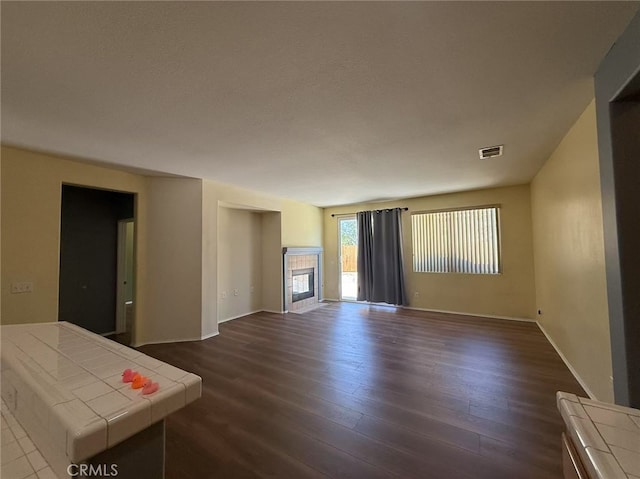 12673 Field Way, Victorville, CA 92395 - unfurnished living room with a tile fireplace and dark wood-style flooring