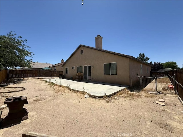 12673 Field Way, Victorville, CA 92395 - back of house featuring a patio area, a fenced backyard, a chimney, and stucco siding