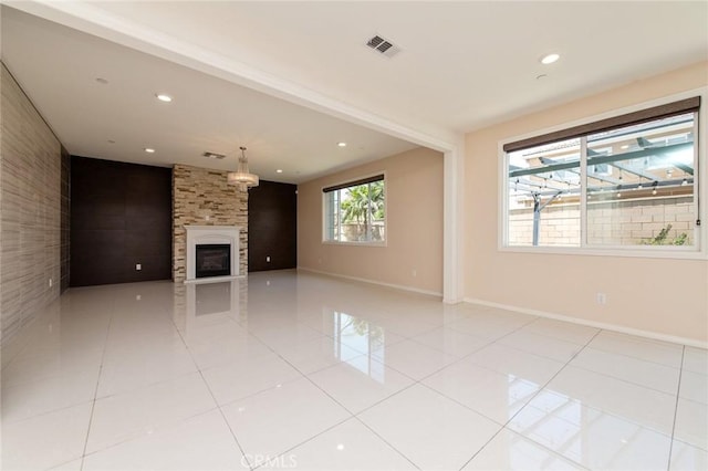 13246 Baxter Springs Dr, Rancho Cucamonga, CA 91739 - unfurnished living room with a fireplace, light tile patterned flooring, recessed lighting, and an accent wall
