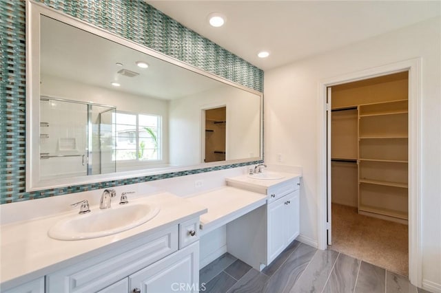 13246 Baxter Springs Dr, Rancho Cucamonga, CA 91739 - bathroom featuring a spacious closet, double vanity, a stall shower, and recessed lighting
