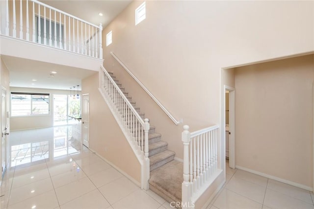 13246 Baxter Springs Dr, Rancho Cucamonga, CA 91739 - staircase with tile patterned floors and a high ceiling