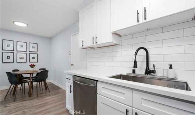 9525 Sylmar Ave Unit 2, Panorama City, CA 91402 - kitchen featuring dishwasher, decorative backsplash, light countertops, and white cabinetry