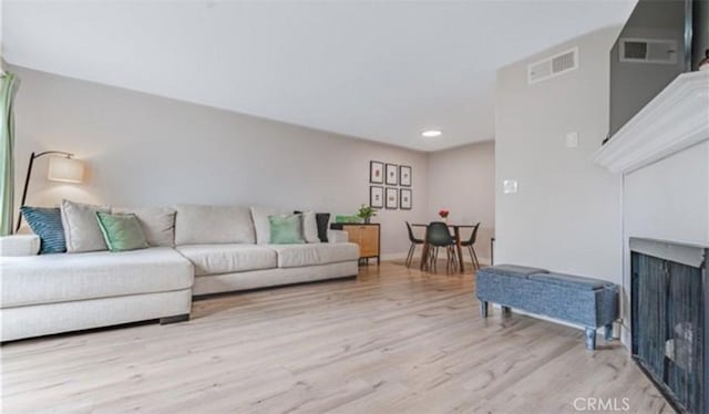 9525 Sylmar Ave Unit 2, Panorama City, CA 91402 - living room featuring light wood finished floors, recessed lighting, and a fireplace