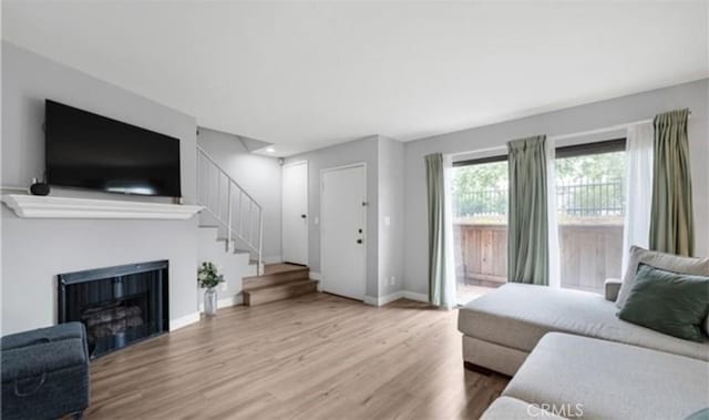 9525 Sylmar Ave Unit 2, Panorama City, CA 91402 - living area with wood finished floors, stairway, and a fireplace