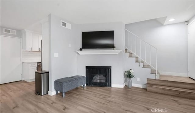 9525 Sylmar Ave Unit 2, Panorama City, CA 91402 - living area with light wood-style floors, stairs, a fireplace, and recessed lighting