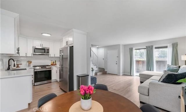 9525 Sylmar Ave Unit 2, Panorama City, CA 91402 - dining space featuring light wood-type flooring and stairs