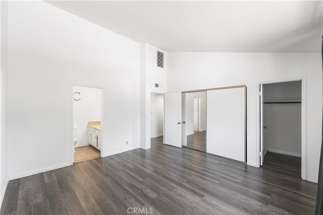 9525 Sylmar Ave Unit 2, Panorama City, CA 91402 - unfurnished bedroom with dark wood-style floors, high vaulted ceiling, and connected bathroom