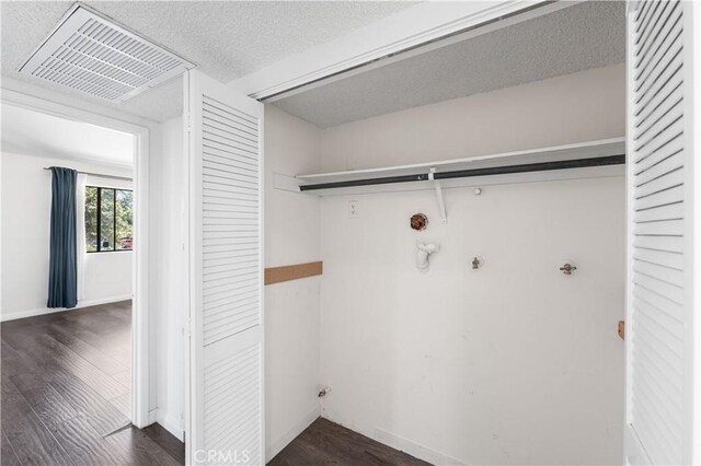 9525 Sylmar Ave Unit 2, Panorama City, CA 91402 - laundry room with dark wood finished floors and a textured ceiling