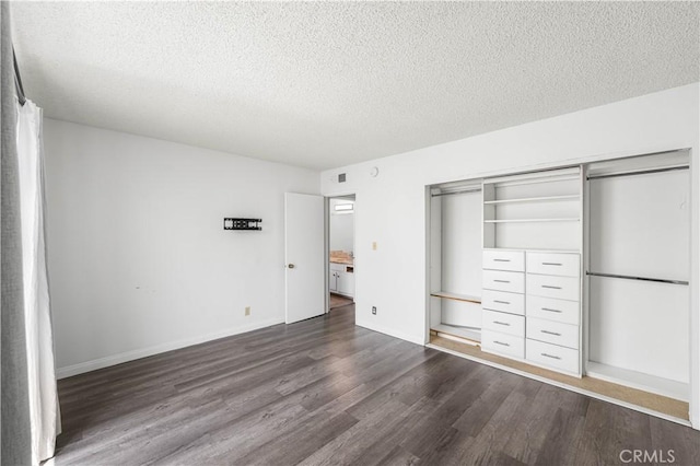 9525 Sylmar Ave Unit 2, Panorama City, CA 91402 - unfurnished bedroom featuring dark wood-type flooring, a textured ceiling, and a closet