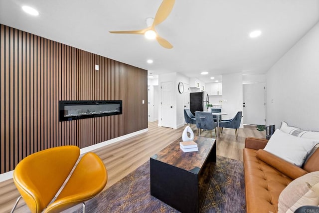 6735 Amherst St Unit 1E, San Diego, CA 92115 - living area featuring wood finished floors, ceiling fan, recessed lighting, and a glass covered fireplace