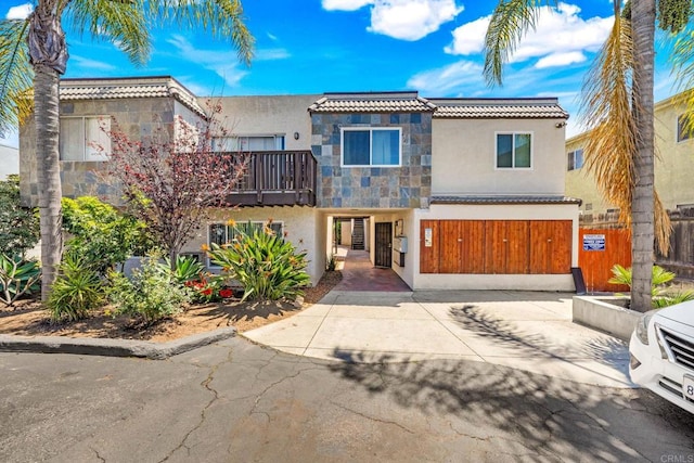 6735 Amherst St Unit 1E, San Diego, CA 92115 - view of front facade with stucco siding, a balcony, and stone siding