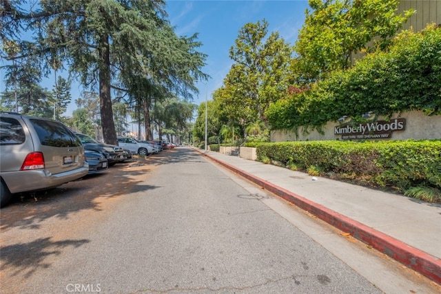 15053 Sherman Way Unit A, Van Nuys, CA 91405 - view of asphalt road featuring sidewalks, curbs, and street lights