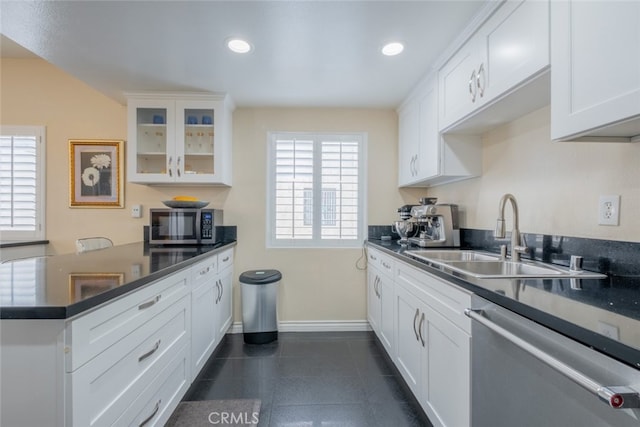 15053 Sherman Way Unit A, Van Nuys, CA 91405 - kitchen with stainless steel appliances, a peninsula, dark countertops, glass insert cabinets, and recessed lighting