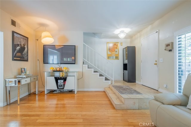 15053 Sherman Way Unit A, Van Nuys, CA 91405 - foyer entrance with wood finished floors and stairs