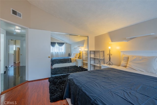 15053 Sherman Way Unit A, Van Nuys, CA 91405 - bedroom featuring lofted ceiling, a closet, wood finished floors, and a textured ceiling