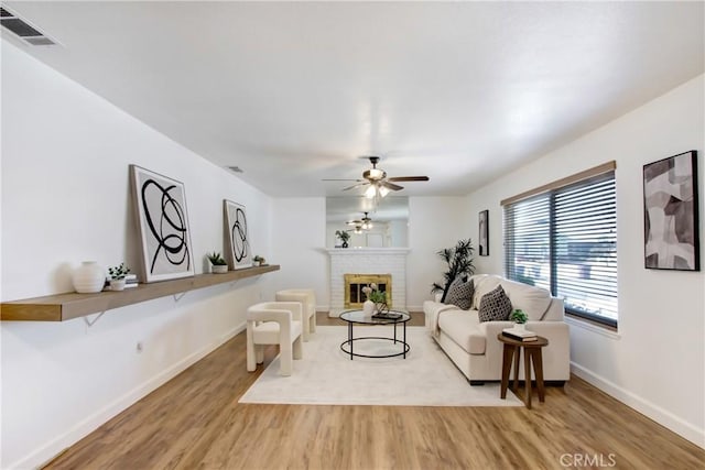 27218 Monk St, Menifee, CA 92586 - living area with wood finished floors, ceiling fan, and a brick fireplace