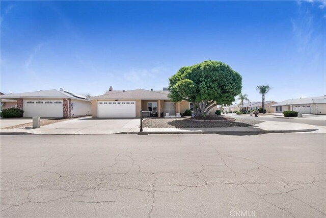 27218 Monk St, Menifee, CA 92586 - view of front of home with a garage, driveway, and a residential view