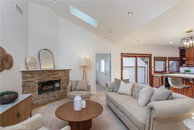 624 S Reese Pl, Burbank, CA 91506 - living room featuring a skylight, a stone fireplace, a chandelier, recessed lighting, and high vaulted ceiling