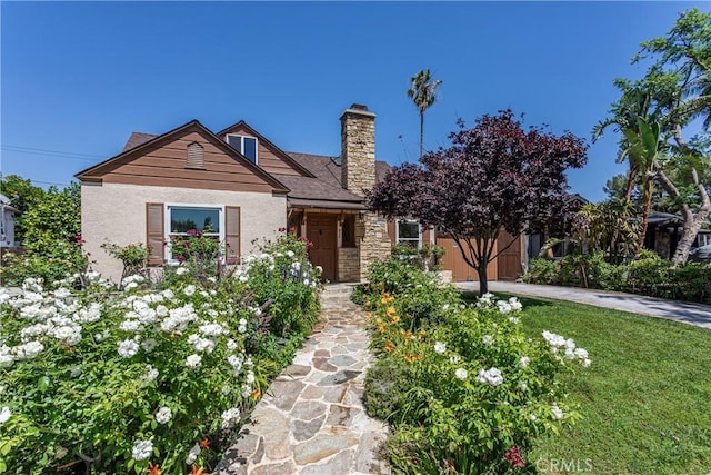 624 S Reese Pl, Burbank, CA 91506 - view of front of property featuring a chimney, stucco siding, a front yard, and stone siding