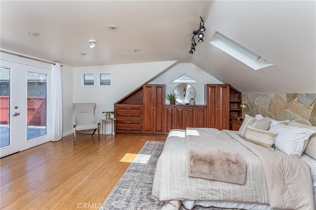624 S Reese Pl, Burbank, CA 91506 - bedroom with french doors, access to outside, a skylight, light wood-style floors, and track lighting