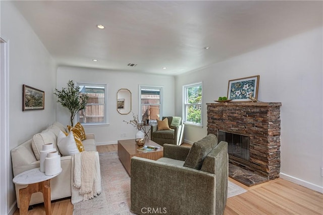 624 S Reese Pl, Burbank, CA 91506 - living room featuring light wood-type flooring, a stone fireplace, and recessed lighting