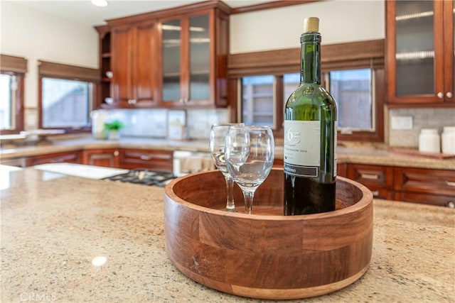 624 S Reese Pl, Burbank, CA 91506 - kitchen view of tasteful backsplash, glass insert cabinets, light countertops, recessed lighting, and brown cabinetry