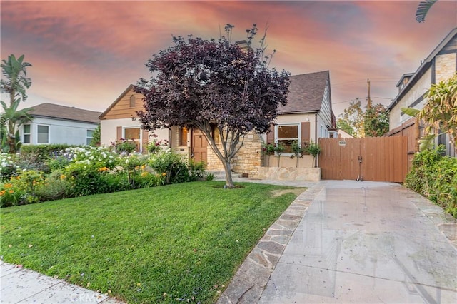 624 S Reese Pl, Burbank, CA 91506 - view of front facade with a gate, stone siding, roof with shingles, and stucco siding