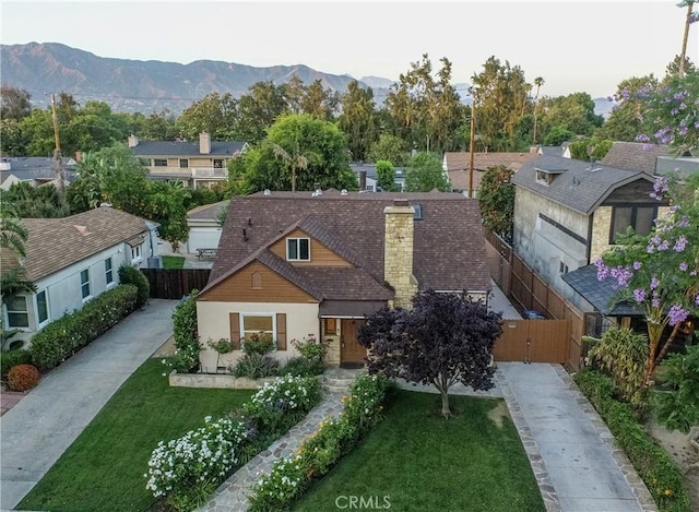 624 S Reese Pl, Burbank, CA 91506 - view of front facade with stucco siding, concrete driveway, a mountain view, and a chimney