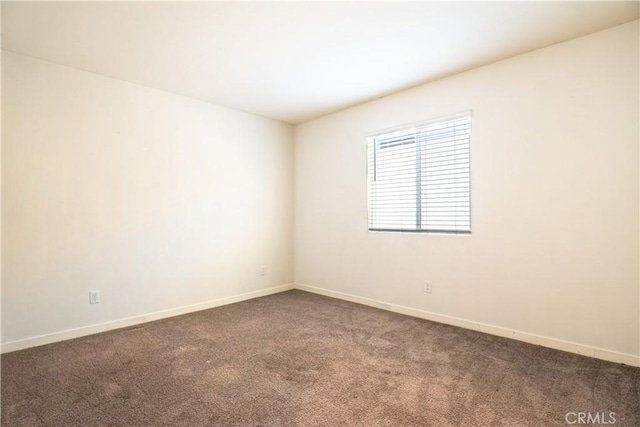 12893 Breccia Way, Moreno Valley, CA 92555 - empty room featuring dark carpet and baseboards