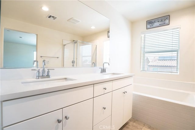 12893 Breccia Way, Moreno Valley, CA 92555 - full bath with double vanity, a bath, a stall shower, tile patterned flooring, and recessed lighting
