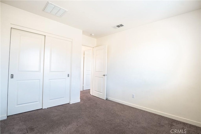12893 Breccia Way, Moreno Valley, CA 92555 - unfurnished bedroom with dark colored carpet and a closet