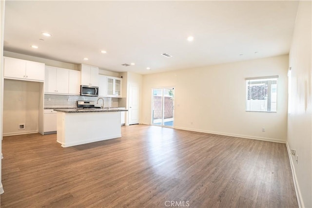 12893 Breccia Way, Moreno Valley, CA 92555 - kitchen featuring appliances with stainless steel finishes, wood finished floors, white cabinets, tasteful backsplash, and recessed lighting