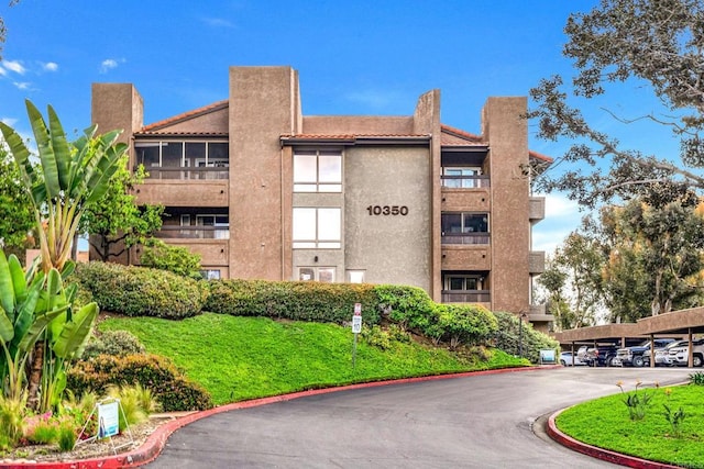 10350 Caminito Cuervo Unit 93, San Diego, CA 92108 - view of building exterior featuring covered parking