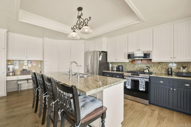 15935 Mac Tan Ln, Valley Center, CA 92082 - kitchen with a raised ceiling, appliances with stainless steel finishes, decorative backsplash, light wood-style flooring, and crown molding