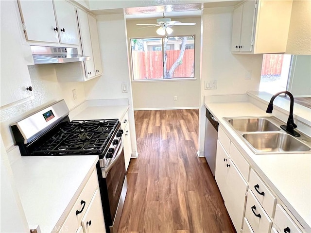13895 Parkway Dr Unit 79, Garden Grove, CA 92843 - kitchen featuring appliances with stainless steel finishes, range hood, wood finished floors, ceiling fan, and white cabinets