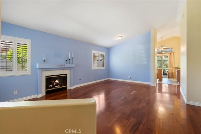 23998 Via Astuto, Murrieta, CA 92562 - unfurnished living room with wood finished floors, a tile fireplace, and lofted ceiling