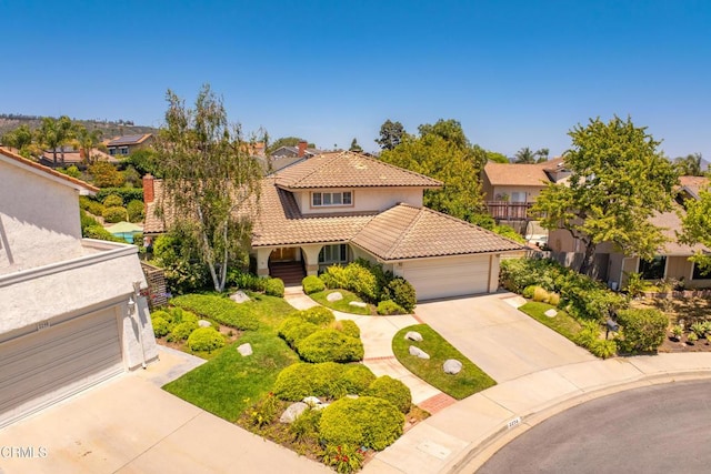 2274 Via Tomas, Camarillo, CA 93010 - mediterranean / spanish house featuring a tiled roof, driveway, an attached garage, stucco siding, and a residential view