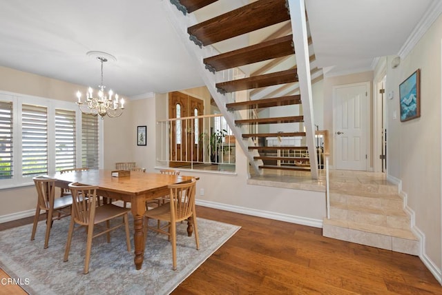 2274 Via Tomas, Camarillo, CA 93010 - dining space with wood finished floors, a chandelier, ornamental molding, and stairway