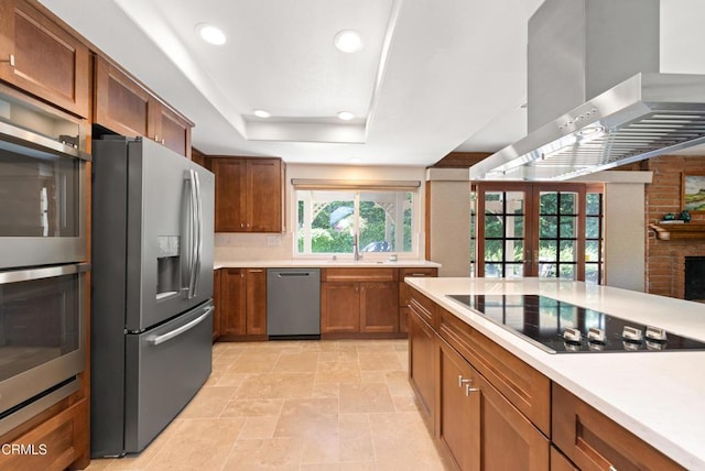 2274 Via Tomas, Camarillo, CA 93010 - kitchen with appliances with stainless steel finishes, wall chimney exhaust hood, light countertops, recessed lighting, and brown cabinetry