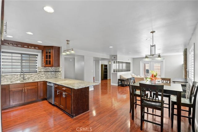 6433 San Marcos Way, Buena Park, CA 90620 - kitchen with dishwasher, a peninsula, wood finished floors, tasteful backsplash, and decorative light fixtures