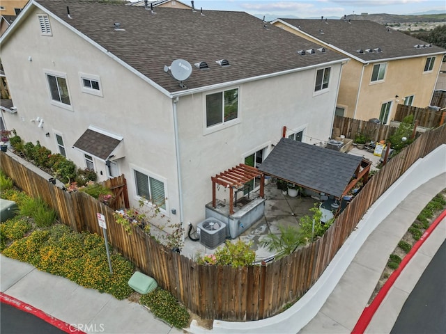 26120 Goldman Pl, Saugus, CA 91350 - view of property exterior with stucco siding, roof with shingles, a patio area, and a fenced backyard