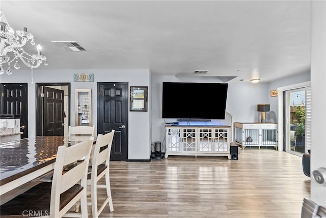26120 Goldman Pl, Saugus, CA 91350 - dining space with a chandelier and wood finished floors