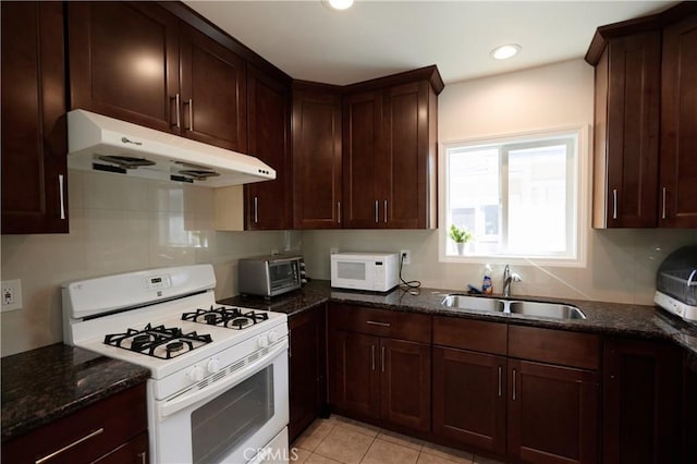 7712 Young Ave, Rosemead, CA 91770 - kitchen featuring white appliances, under cabinet range hood, dark stone countertops, recessed lighting, and light tile patterned flooring