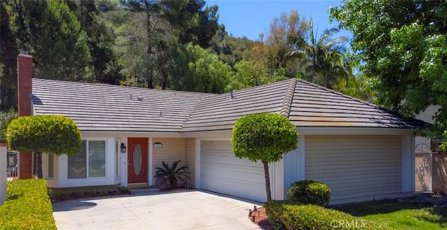 21812 Raintree Ln, Lake Forest, CA 92630 - single story home with a garage, concrete driveway, a chimney, and a tiled roof