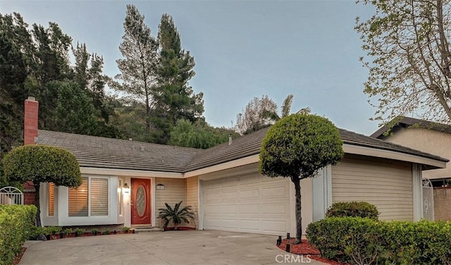 21812 Raintree Ln, Lake Forest, CA 92630 - single story home with concrete driveway, an attached garage, and a chimney