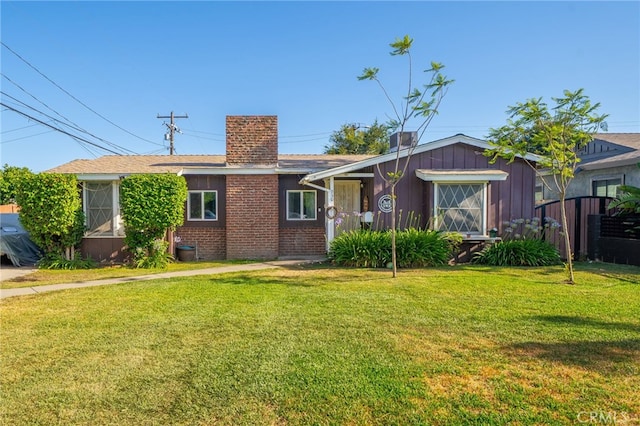 950 E Yale St, Ontario, CA 91764 - single story home with a chimney, a front lawn, brick siding, and board and batten siding