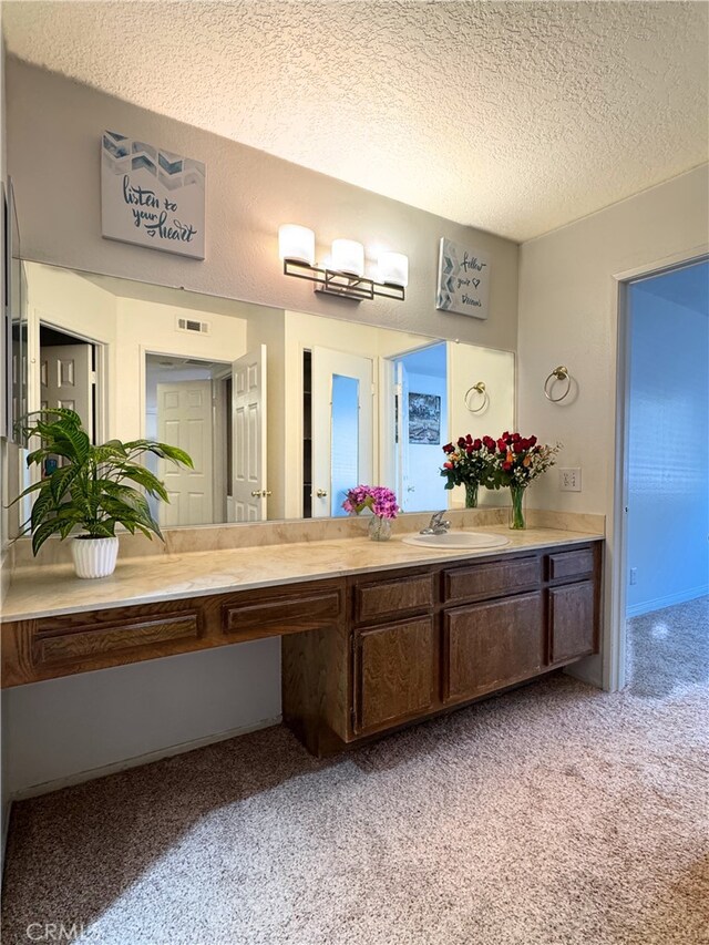 1480 W Edgehill Rd Unit 58, San Bernardino, CA 92405 - bathroom with carpet flooring, a textured ceiling, and vanity