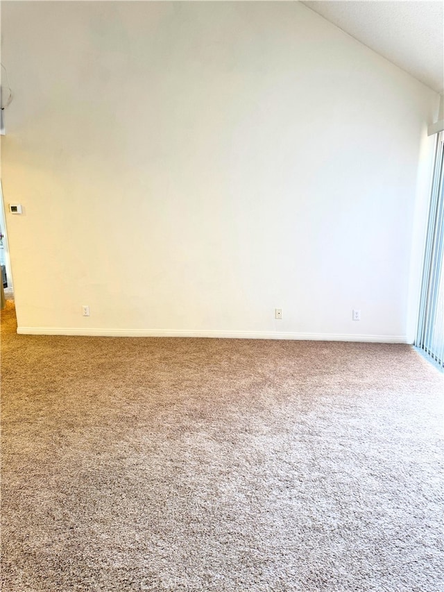 1480 W Edgehill Rd Unit 58, San Bernardino, CA 92405 - carpeted empty room with vaulted ceiling and baseboards