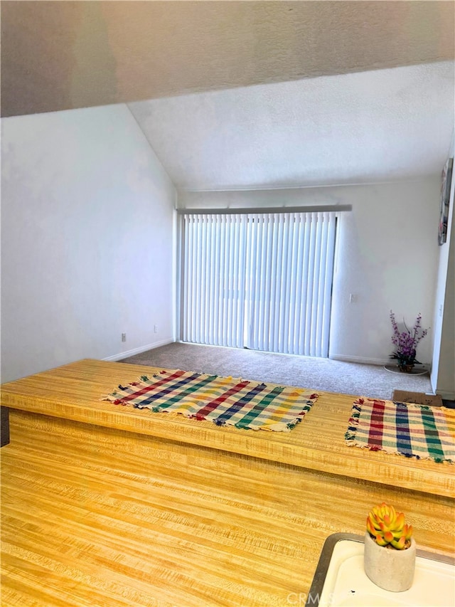 1480 W Edgehill Rd Unit 58, San Bernardino, CA 92405 - unfurnished living room featuring carpet and baseboards