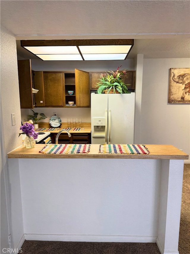 1480 W Edgehill Rd Unit 58, San Bernardino, CA 92405 - kitchen featuring white refrigerator with ice dispenser, carpet, and light countertops